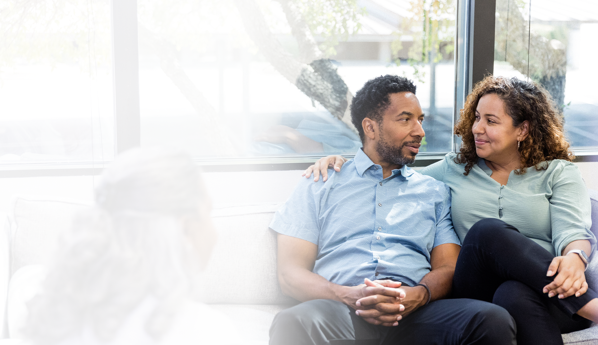 Partners smiling at each other in doctors office 